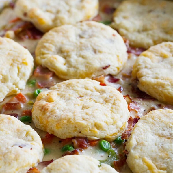 What can be better than a creamy chicken and bacon pot pie, topped with bacon cheddar biscuits? It is said that bacon makes everything better, and this Chicken and Bacon Pot Pie with Bacon Cheddar Biscuits is proof that it is true!