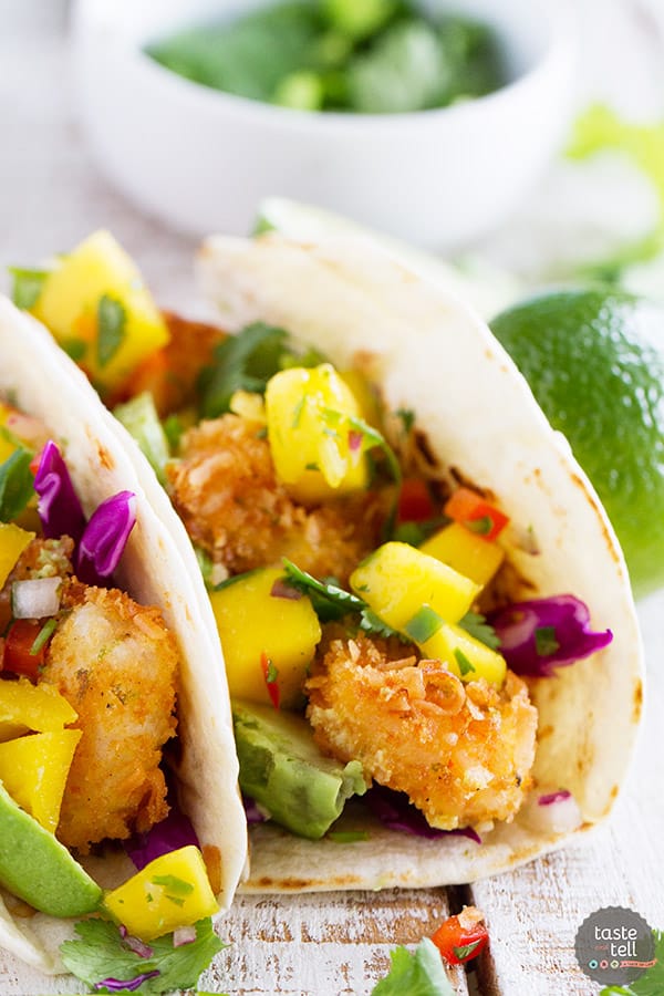 Crispy coconut crusted shrimp are topped with a sweet and spicy mango salsa in this Coconut Shrimp Taco Recipe that brings a taste of the tropics to taco night!