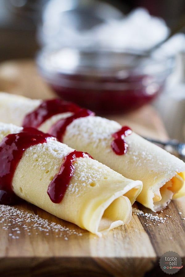 These Monte Cristo Crepes are sweet and savory and perfect for breakfast, brunch or dinner! Tender crepes are filled with cheese, ham and turkey and topped with raspberry jam and powdered sugar.