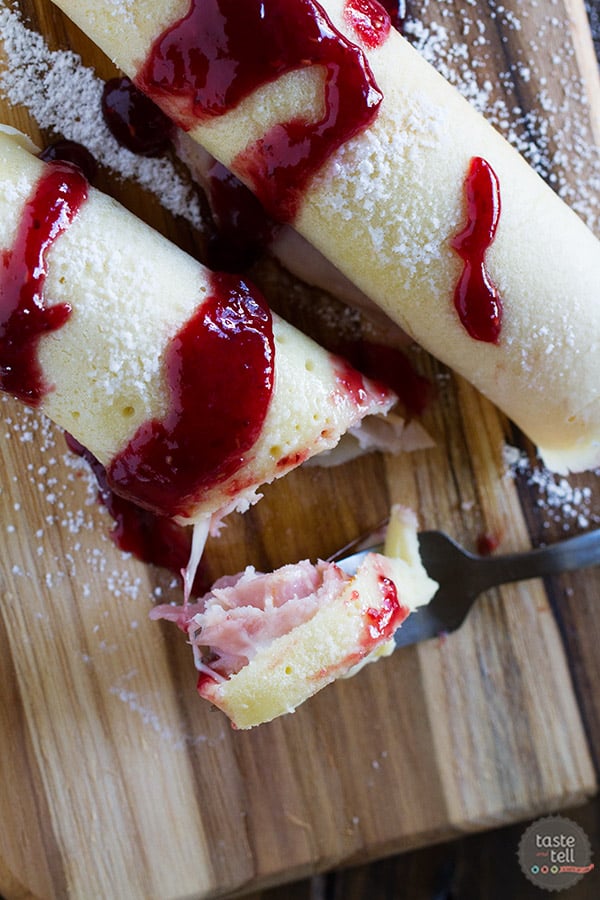These Monte Cristo Crepes are sweet and savory and perfect for breakfast, brunch or dinner! Tender crepes are filled with cheese, ham and turkey and topped with raspberry jam and powdered sugar.