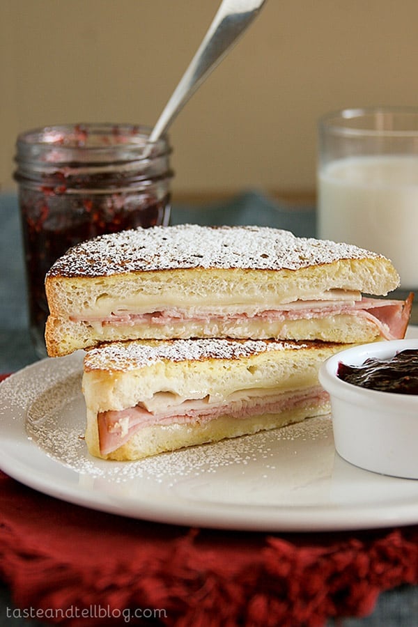 A traditional Monte Cristo Sandwich -a turkey, ham and cheese sandwich served between 2 slices of French toast, dusted with powdered sugar and served with raspberry jam.