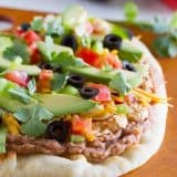 Looking for a fast, easy appetizer or main dish? This 7 Layer Flatbread Recipe takes a favorite dip and turns it into a hearty dish that is perfect for a party.
