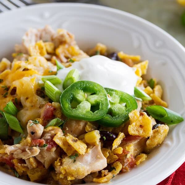 Look no further for an easy slow cooker dinner recipe! This Slow Cooker Cheesy Chicken and Frito Casserole comes together quickly and you can never go wrong when there are Fritos involved!