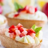 Light and lemony, these Lemon Cream Taco Boats have cinnamon-sugar coated tortilla boats filled with a creamy, luscious lemon cream. Top them off with diced strawberries for a perfect summer treat.