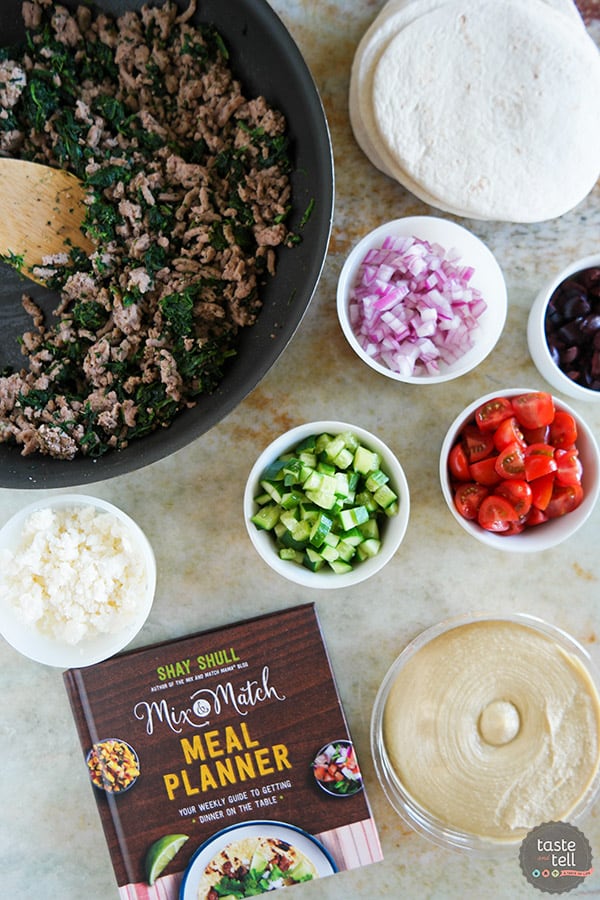 These Greek Tacos are anything but boring - filled with ground turkey with spinach and topped with hummus, feta, and lots of veggies. Give your Taco Tuesday some excitement!