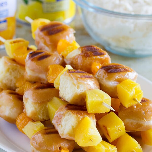 Keep your summer dessert fresh and easy with these Grilled Donut and Fruit Kabobs with Mascarpone Cream. Donut holes, pineapple chunks and mandarin oranges are grilled and served with a luscious cream.