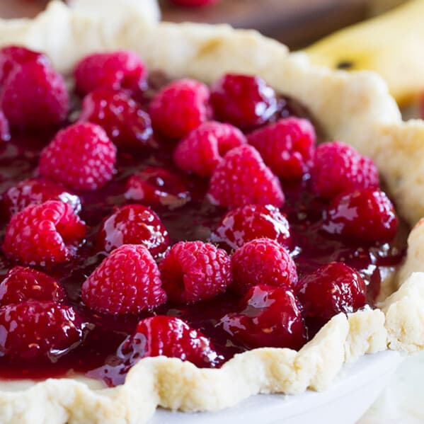 Banana cream pie meets raspberry goodness in this Raspberry Banana Pie recipe that is sweet and creamy and perfect. Who would have ever guessed that raspberry and banana were such a perfect match?