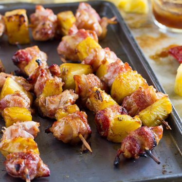Bacon wrapped chicken thighs and chunks of pineapple are marinated in teriyaki sauce in these easy Bacon Wrapped Teriyaki Chicken Skewers. The perfect grilling dinner!