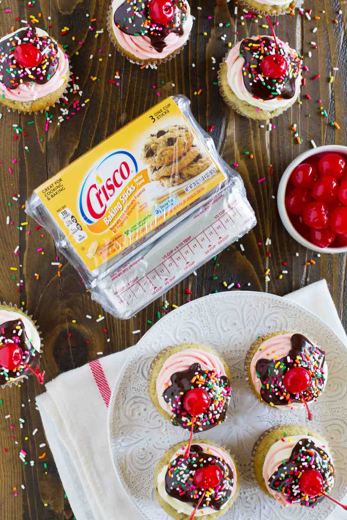 overhead view of banana split cupcakes and package of crisco baking sticks