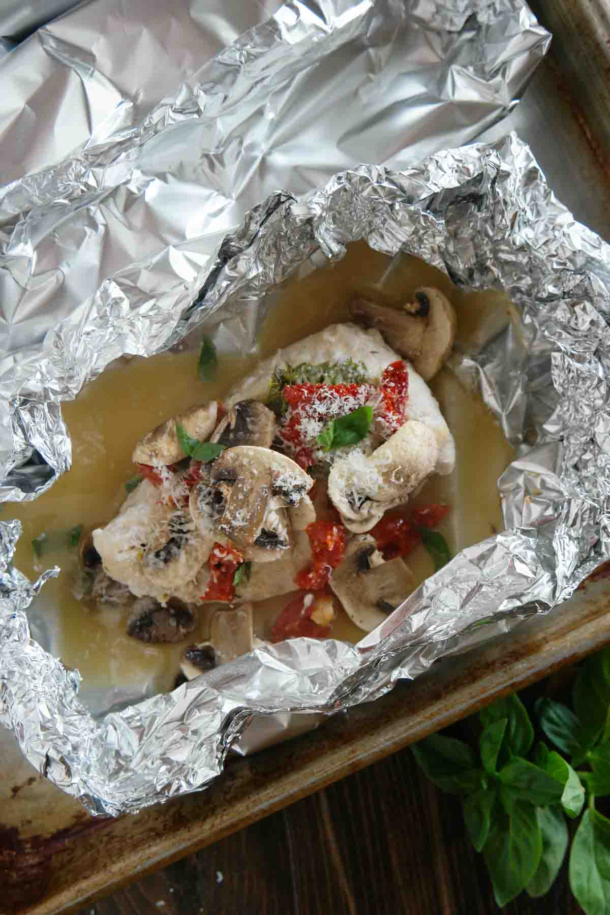 chicken with mushrooms and sun dried tomatoes in foil.