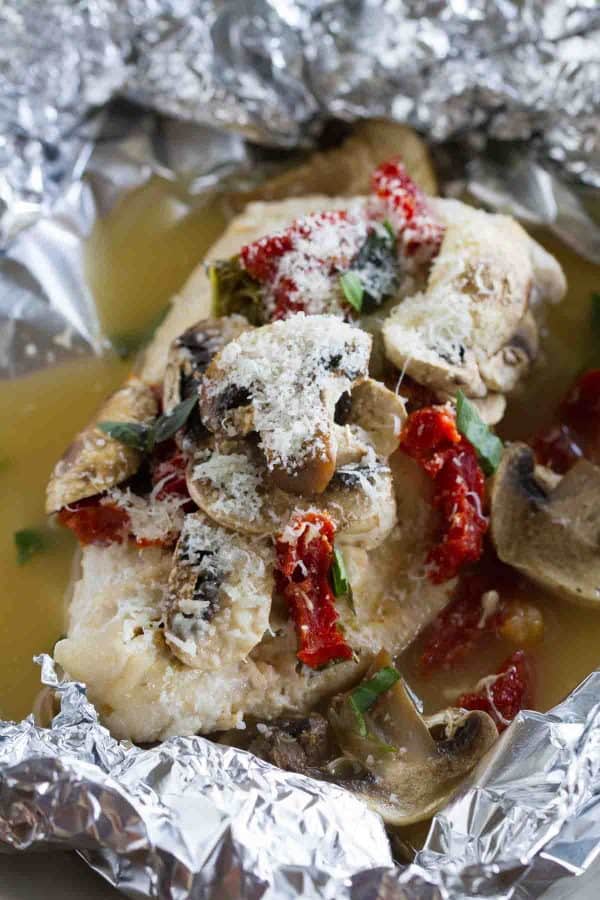 Healthy and fast, this Chicken Milano Foil Packet Recipe is great for a weeknight.  The chicken is moist and flavorful, and clean up is a breeze!