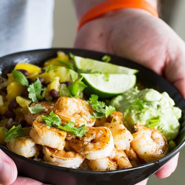 Sweet, spicy and savory - these Spicy Shrimp Bowls have it all going on! Made with rice, beans, pineapple, mango, avocado and spicy shrimp, these bowls are light yet comforting.