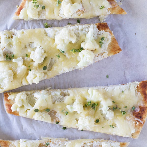 Perfect for an easy, vegetarian lunch, this Easy Flatbread Recipe with Cauliflower and Gruyere only takes minutes to make and is filling and full of flavor.