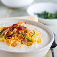 Crockpot Potato Soup topped with cheese, bacon and chives