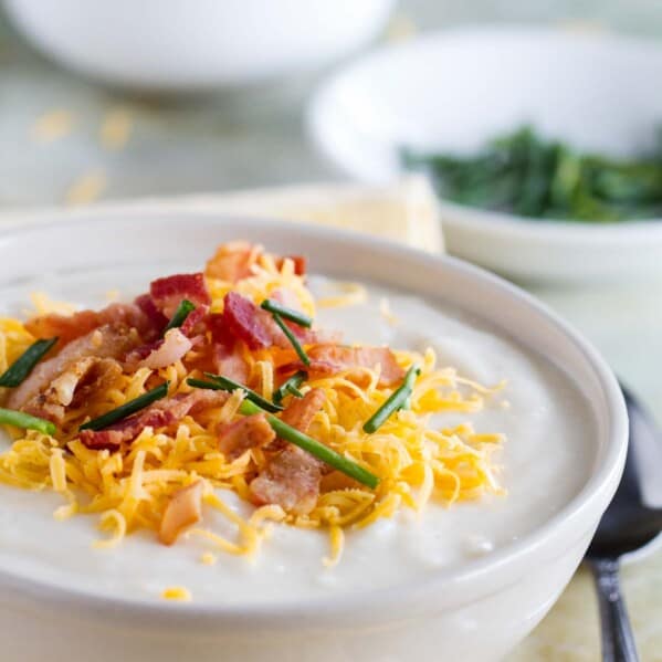 Crockpot Potato Soup topped with cheese, bacon and chives