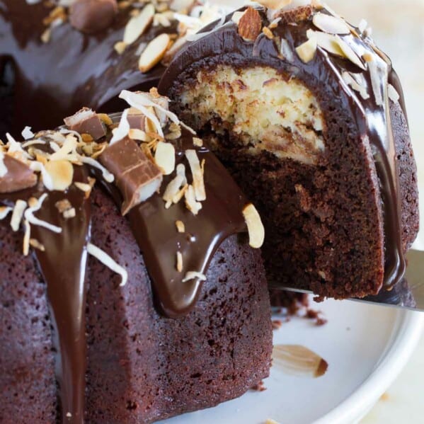 Almond Joy Candy Bar Filled Bundt Cake with a slice being taken out