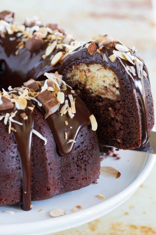 Almond Joy Candy Bar Filled Bundt Cake with a slice being taken out