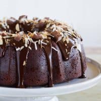 full Almond Joy Candy Bar Filled Bundt Cake on a pedestal