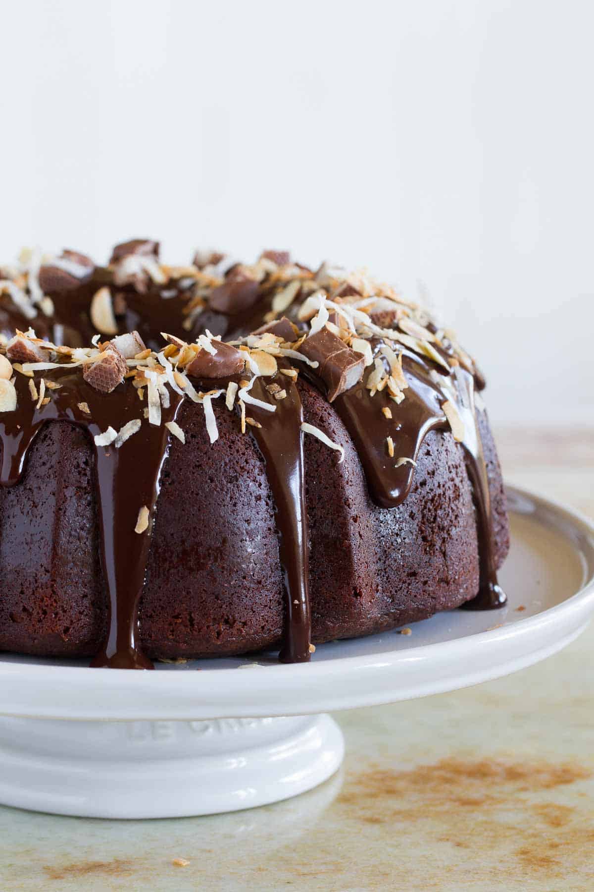 full Almond Joy Candy Bar Filled Bundt Cake on a pedestal