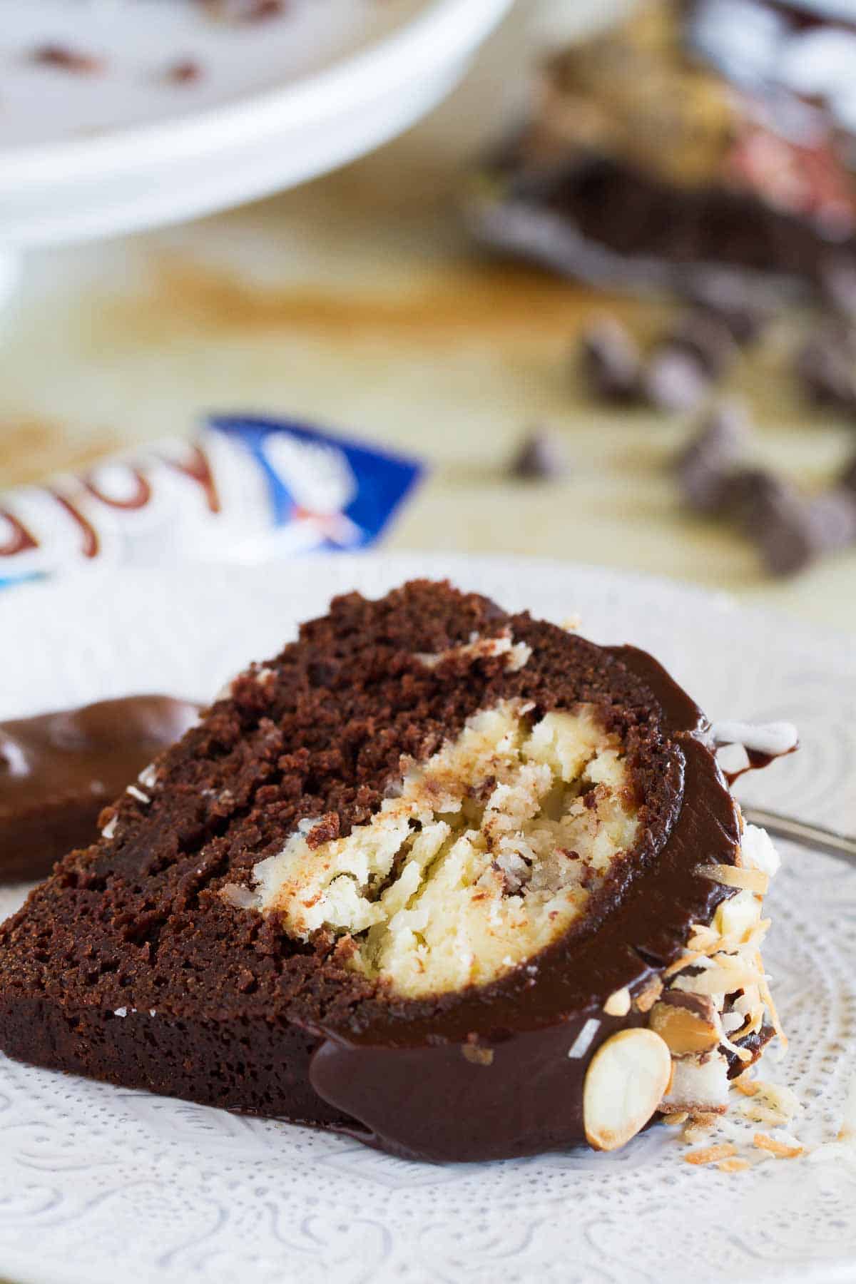 slice of Almond Joy Candy Bar Filled Bundt Cake on a plate showing center of cake