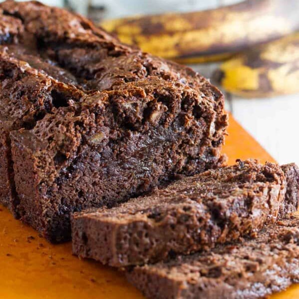 Loaf of sliced Brownie Mix Banana Bread on a cutting board.