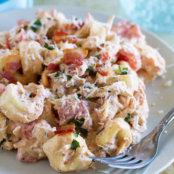 This Creamy Tomato Tortellini with Chicken and Bacon is super simple and makes a perfect weeknight dinner. Frozen tortellini and rotisserie chicken make it a super fast meal, too!