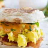 close up photo of bacon and eggs benedict sandwich