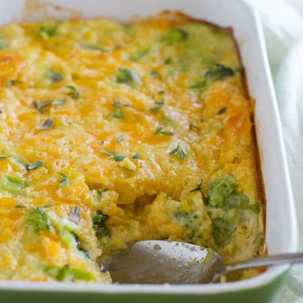 Scalloped Corn and Broccoli in a casserole dish with serving spoon