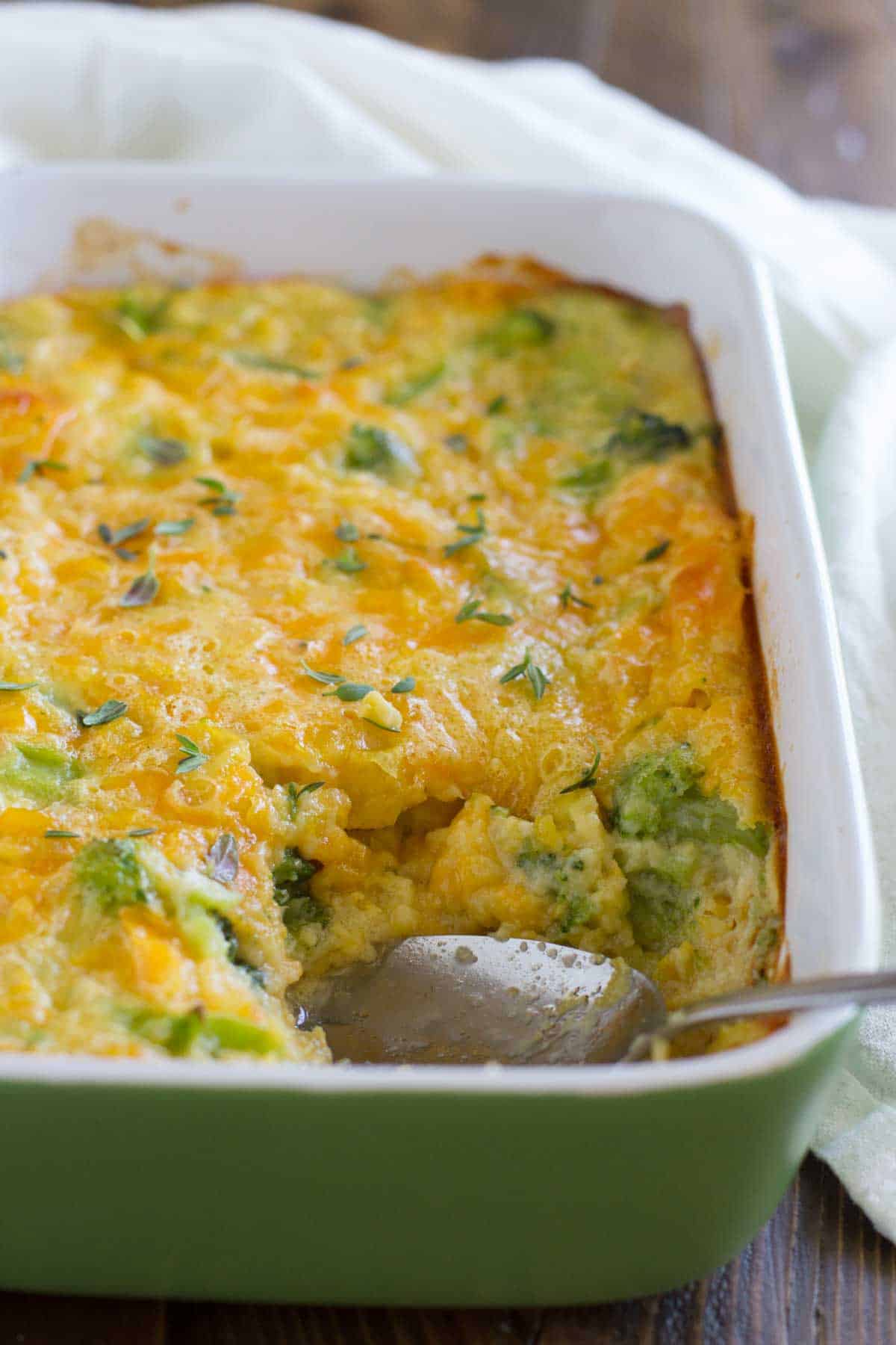 Scalloped Corn and Broccoli in a casserole dish with serving spoon