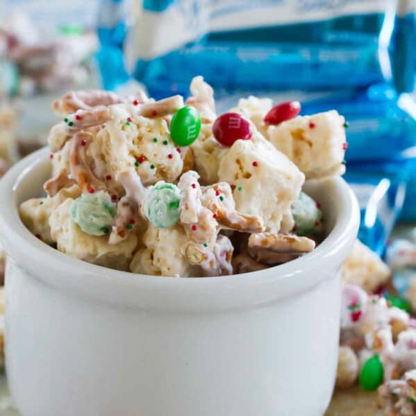 Sweet and salty Christmas mix in a bowl, spilling over.