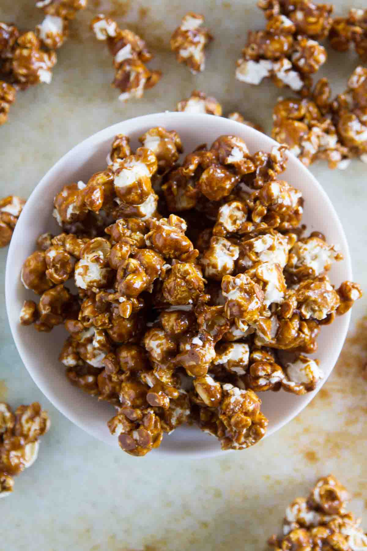 bowl of Caramel Gingerbread Popcorn with some spilling out