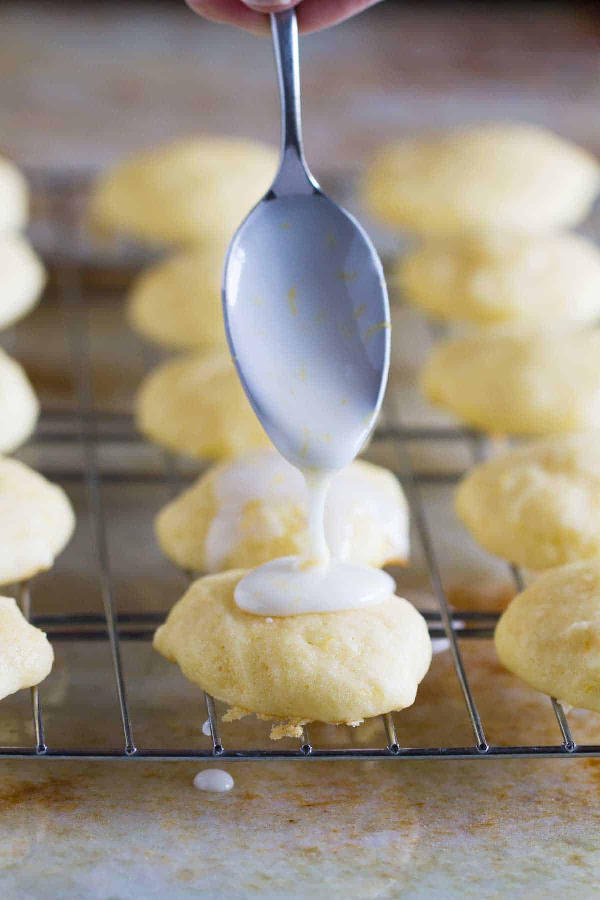 drizzling glaze on ricotta cookies