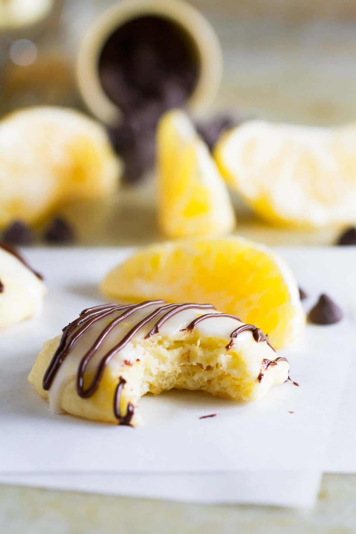 ricotta cookie drizzled with chocolate with a bite taken from it