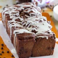 Loaf of chocolate pull apart bread drizzled with icing.
