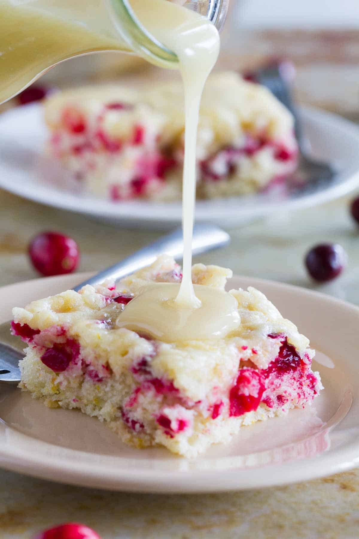 pouring warm butter sauce over cranberry cake