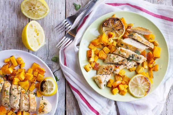 Simple and healthy, this Easy Lemon Chicken with Butternut Squash serves up roasted chicken breasts doused in lemon juice over roasted butternut squash.