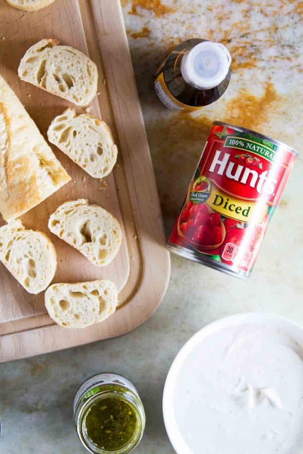 A true crowd pleasing appetizer, this Feta, Pesto and Tomato Bruschetta is a tasty appetizer that can be served year round. Perfect as a starter or as a holiday party appetizer.