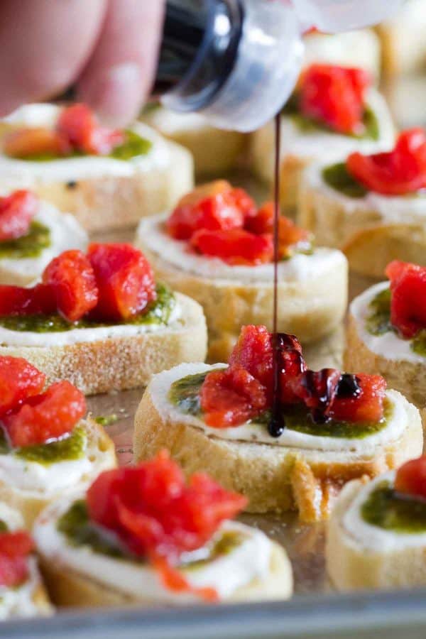 A true crowd pleasing appetizer, this Feta, Pesto and Tomato Bruschetta is a tasty appetizer that can be served year round. Perfect as a starter or as a holiday party appetizer.