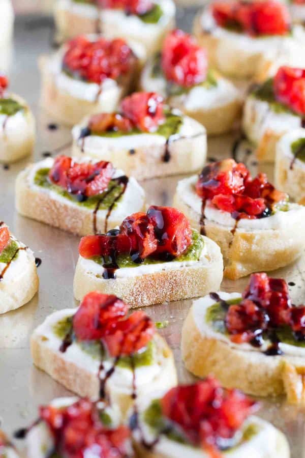 A true crowd pleasing appetizer, this Feta, Pesto and Tomato Bruschetta is a tasty appetizer that can be served year round. Perfect as a starter or as a holiday party appetizer.