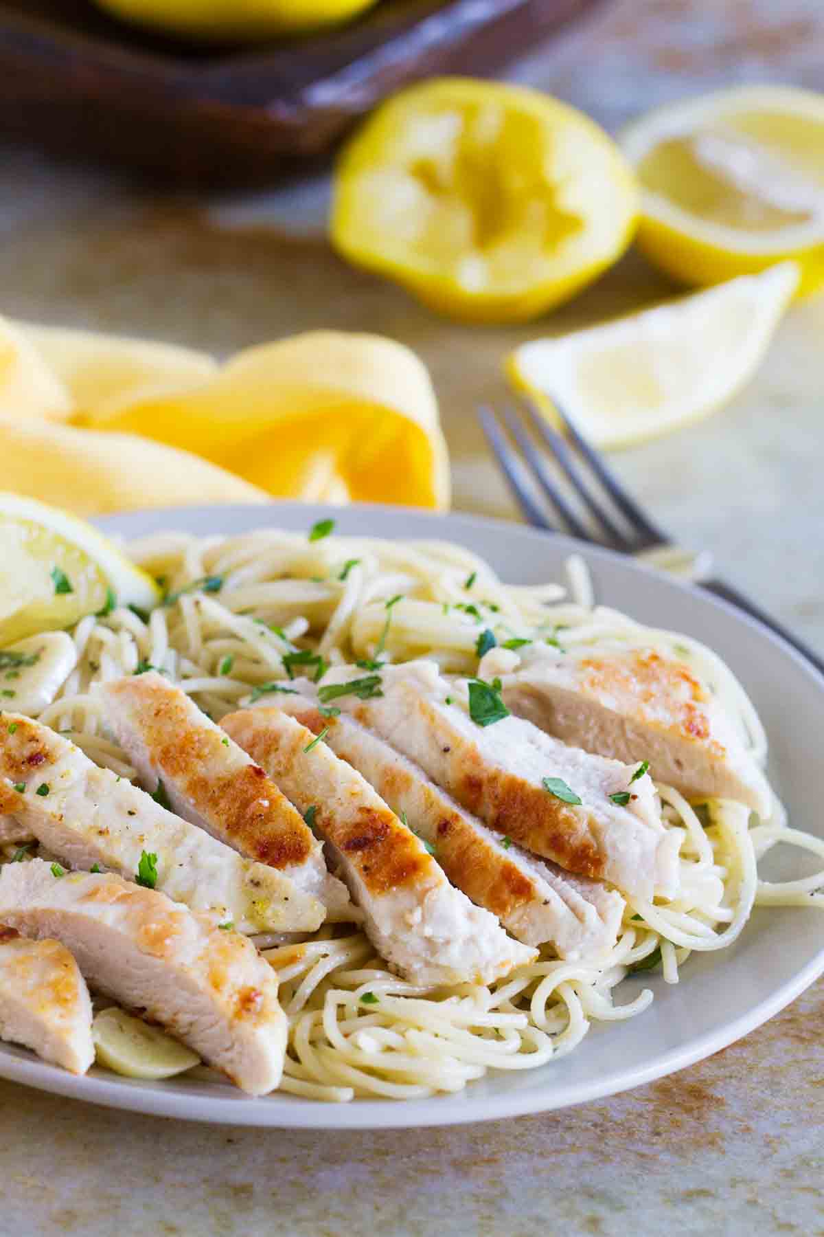 Lemon Chicken Pasta on a plate topped with parsley