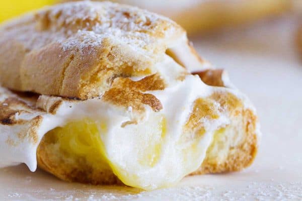 Lemon meringue lovers will go crazy for these Lemon Meringue Eclairs – pate a choux eclair shells filled with lemon curd and then topped with toasted meringue.