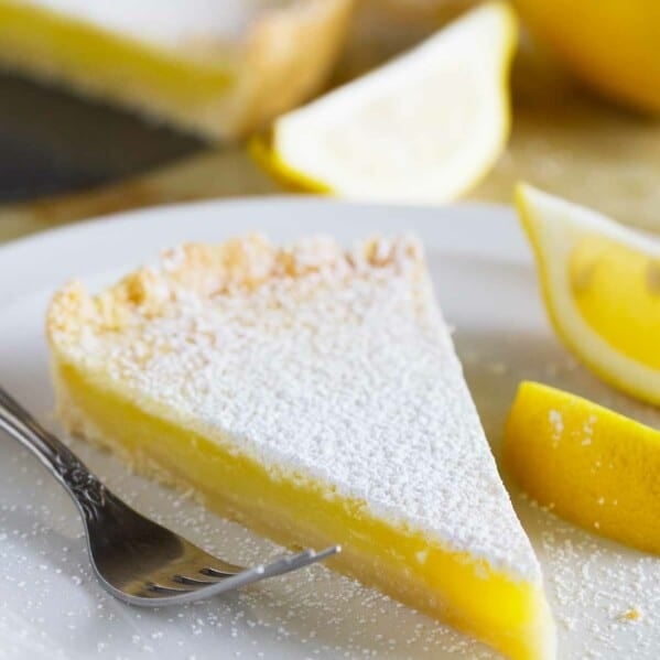 Slice of shortbread lemon tart on a plate.