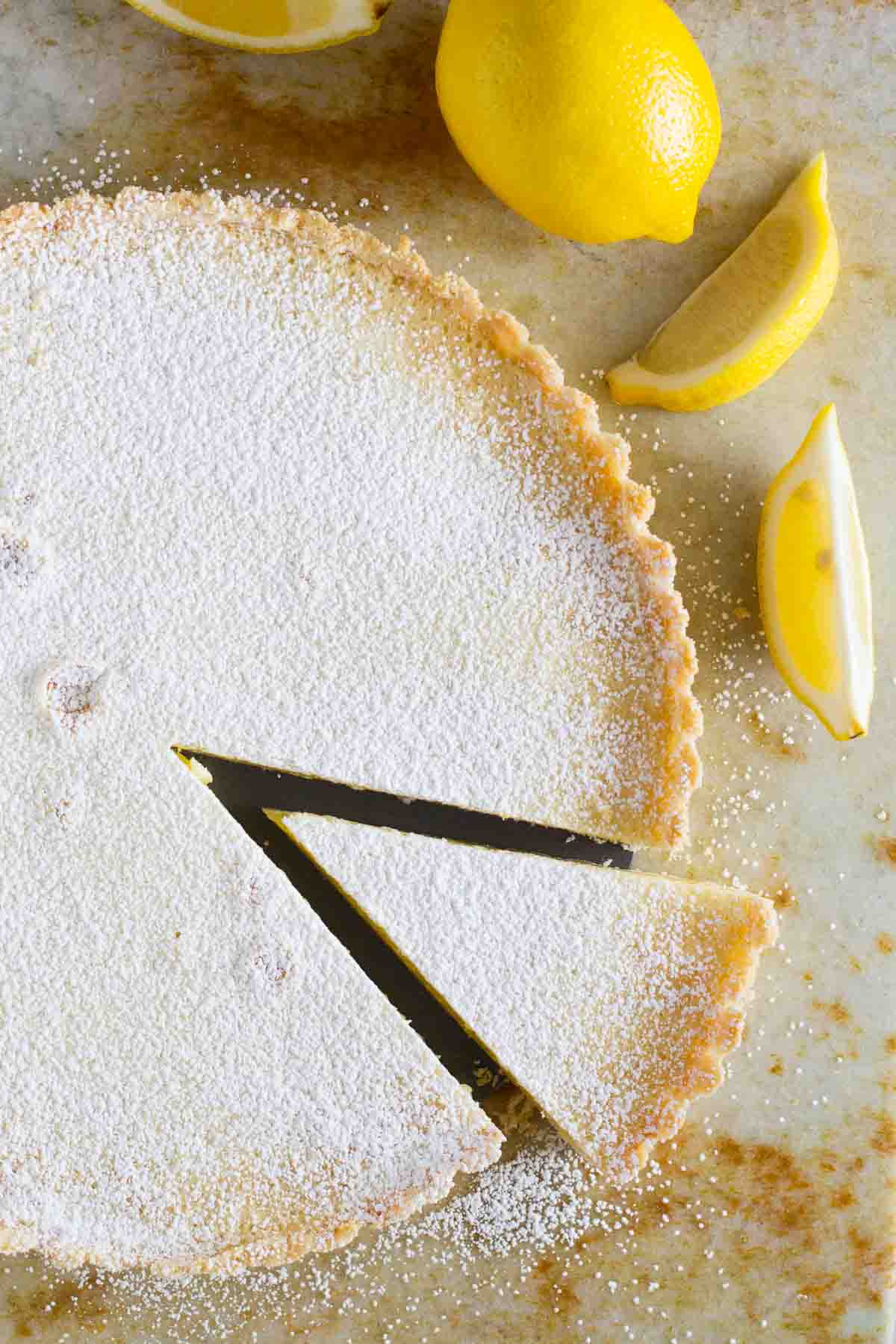 Shortbread lemon tart with a slice cut out.