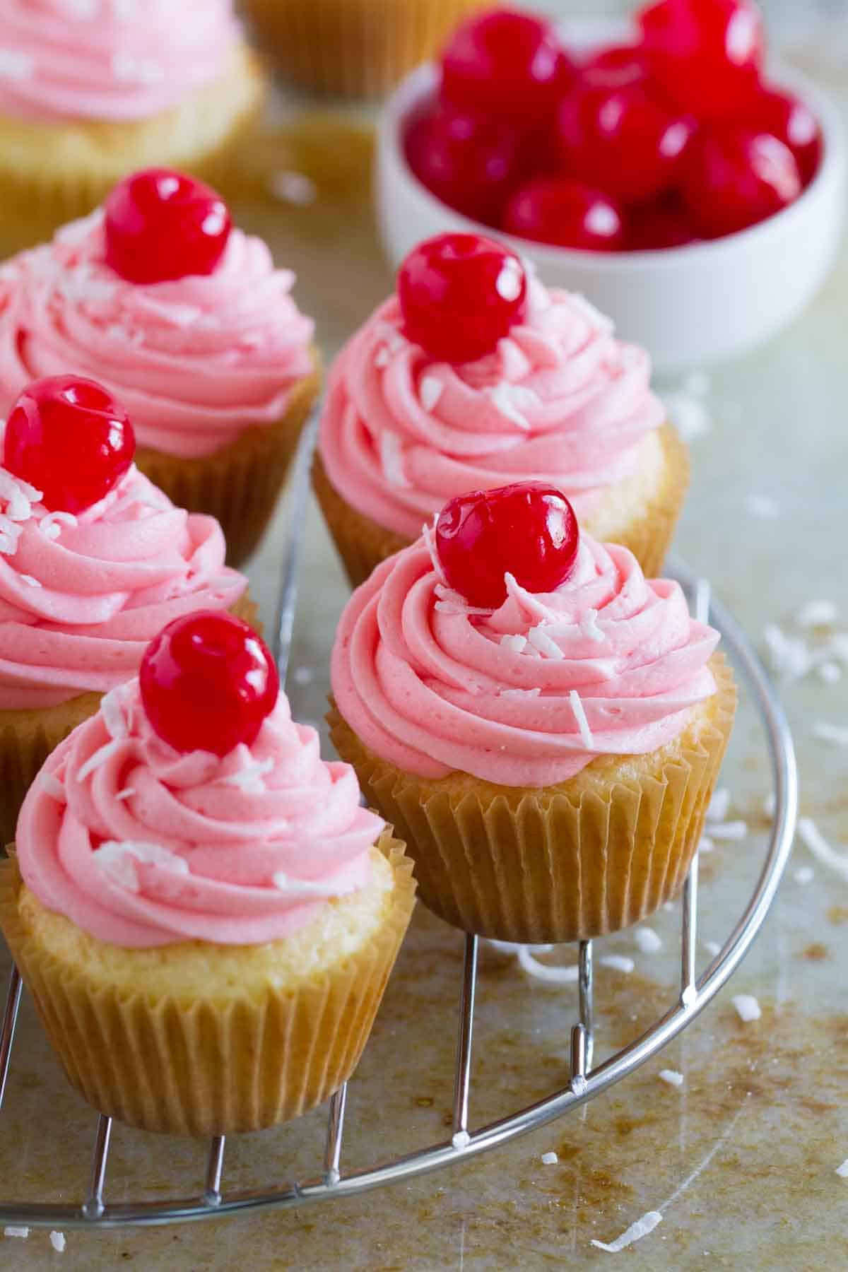 Coconut Cherry Cupcakes on a cooling rack