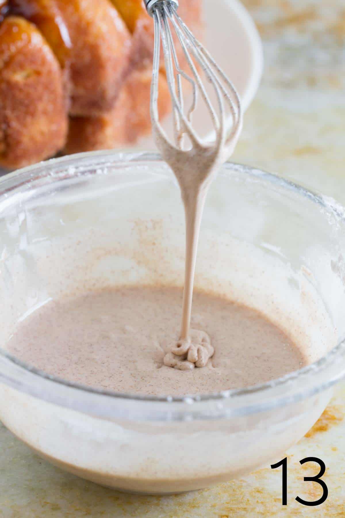 cinnamon glaze for monkey bread on a whisk