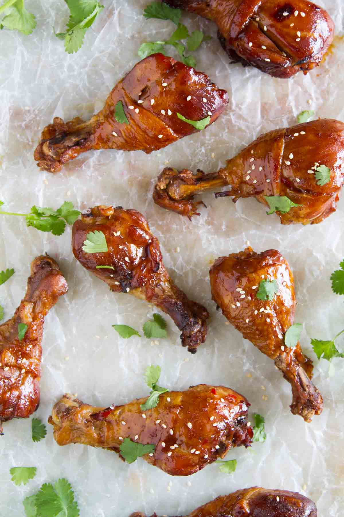 Slow Cooker Sweet Chili Chicken Drumsticks on a piece of parchment