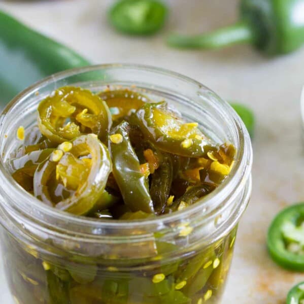 Small jar filled with candied jalapeños.