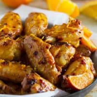 Chipotle Orange Chicken Wings with orange zest sprinkled on top.