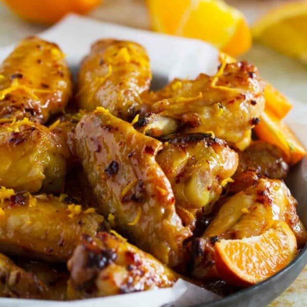 Chipotle Orange Chicken Wings with orange zest sprinkled on top.