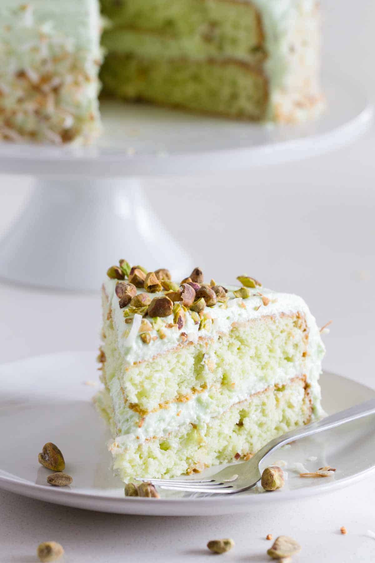 Slice of Pistachio Pudding Cake on a plate.